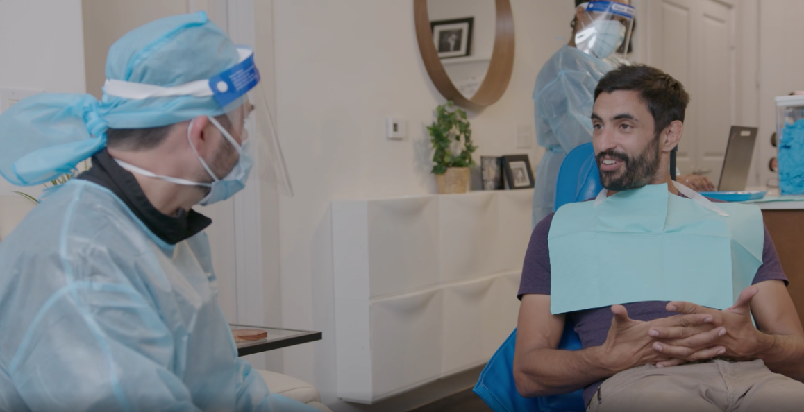 Dentist talking with patient at outset of at-home appointment.